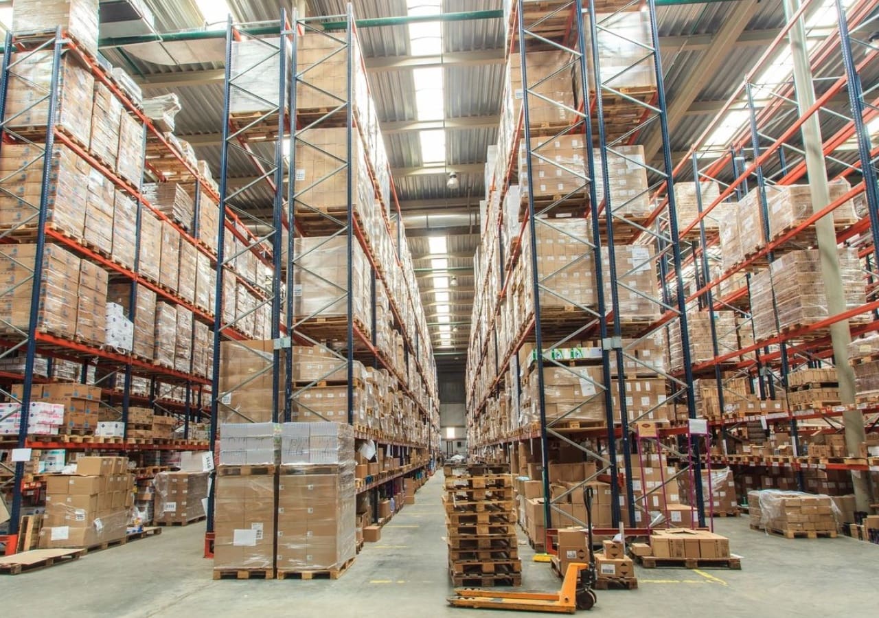 A warehouse filled with lots of boxes and pallets.