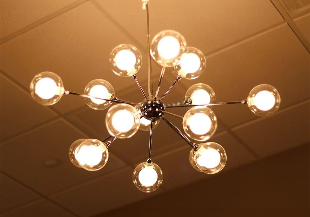 A chandelier with 1 5 lights hanging from the ceiling.